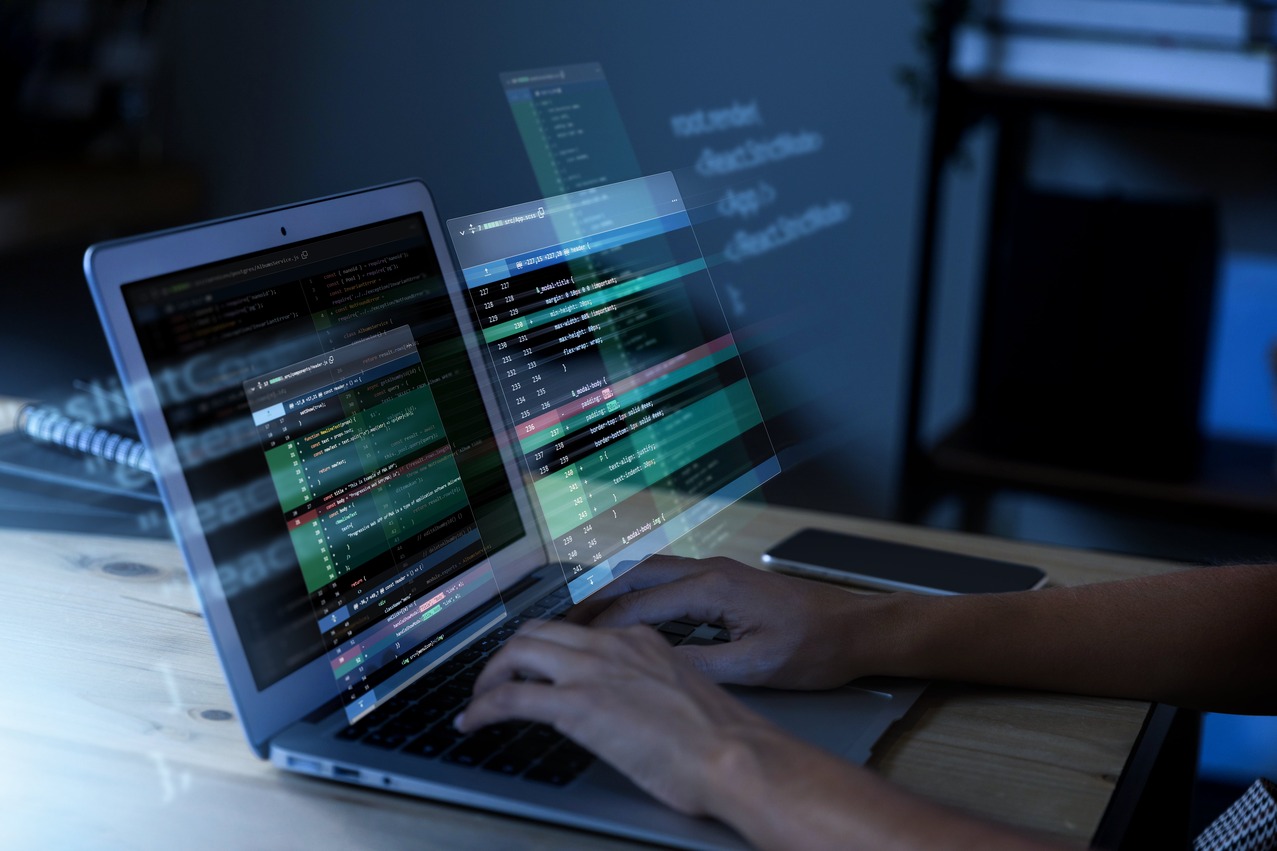 programming-background-with-person-working-with-codes-computer-min